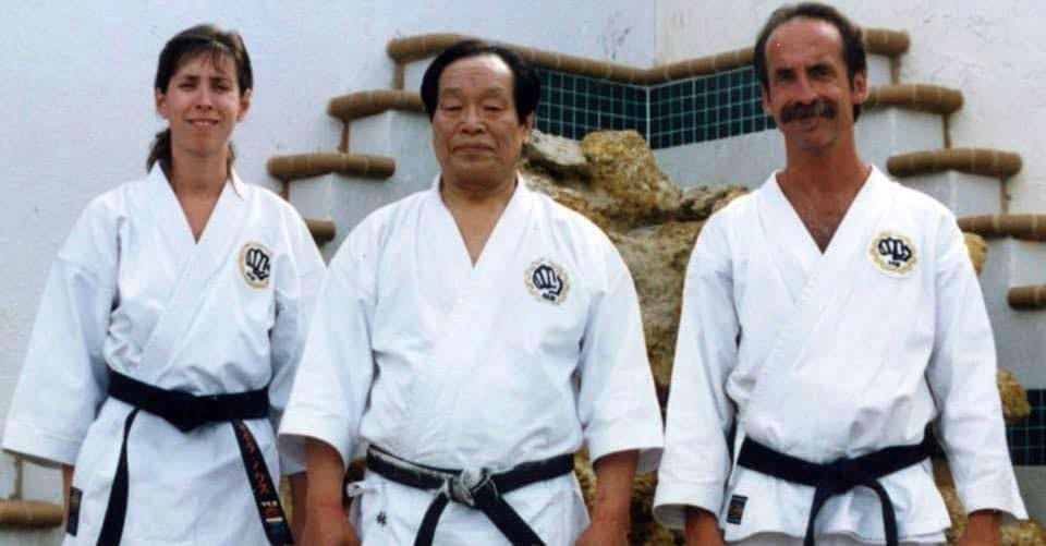 Sensei Myra Noss, Soke Teruo Hayashi and Shihan Reed Noss standing together in gi
